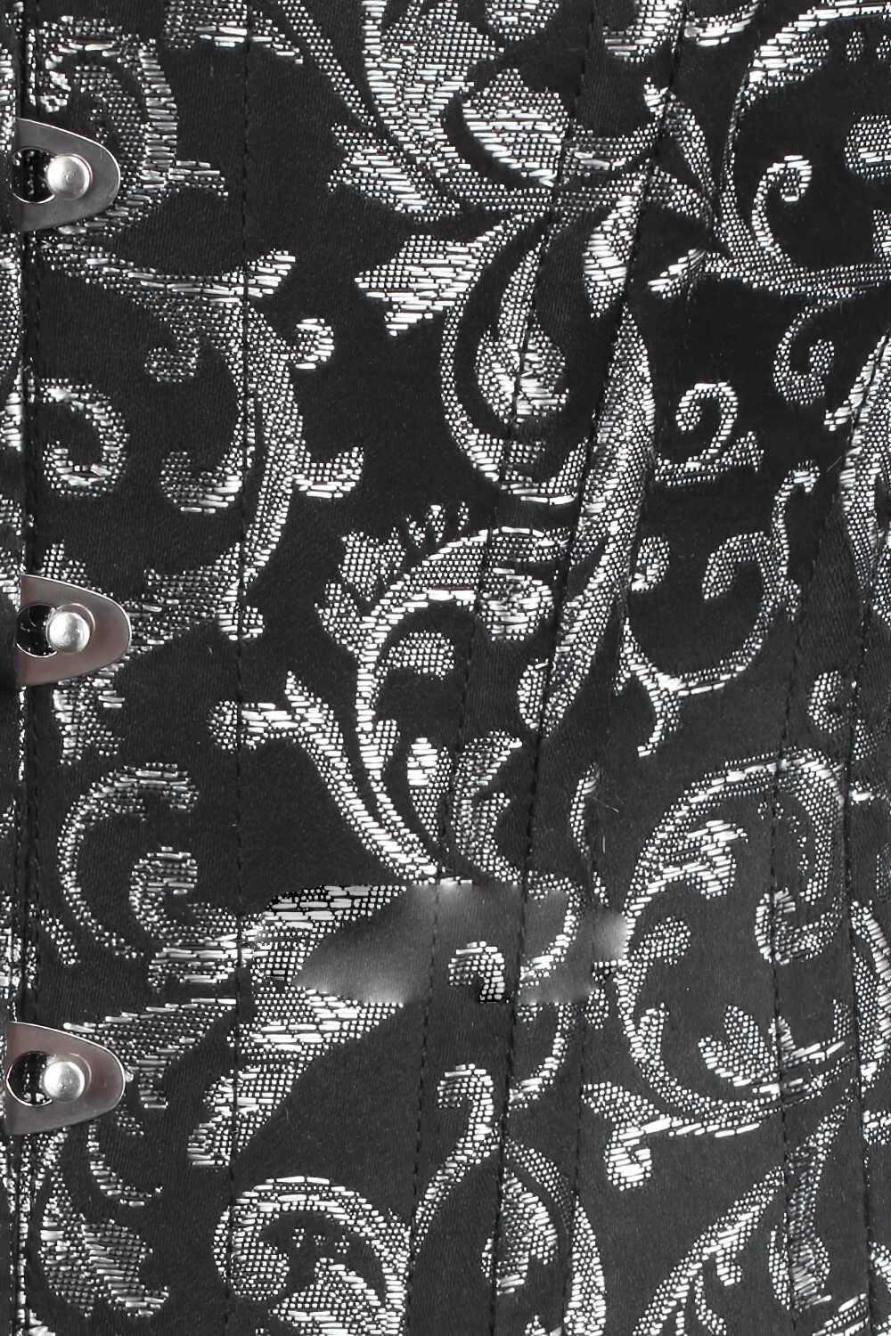 Close-up of structured silver brocade underbust corset showcasing intricate detailing and stylish lacing.