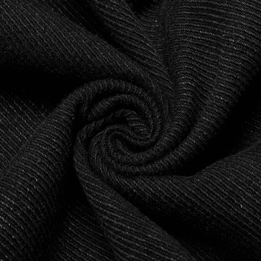 Close-up of soft black denim fabric, showcasing its unique texture and weave for a studded jacket.