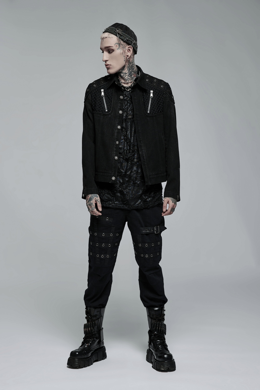 Trendy model wearing a studded black denim jacket, styled with rugged punk urban fashion for a striking look.