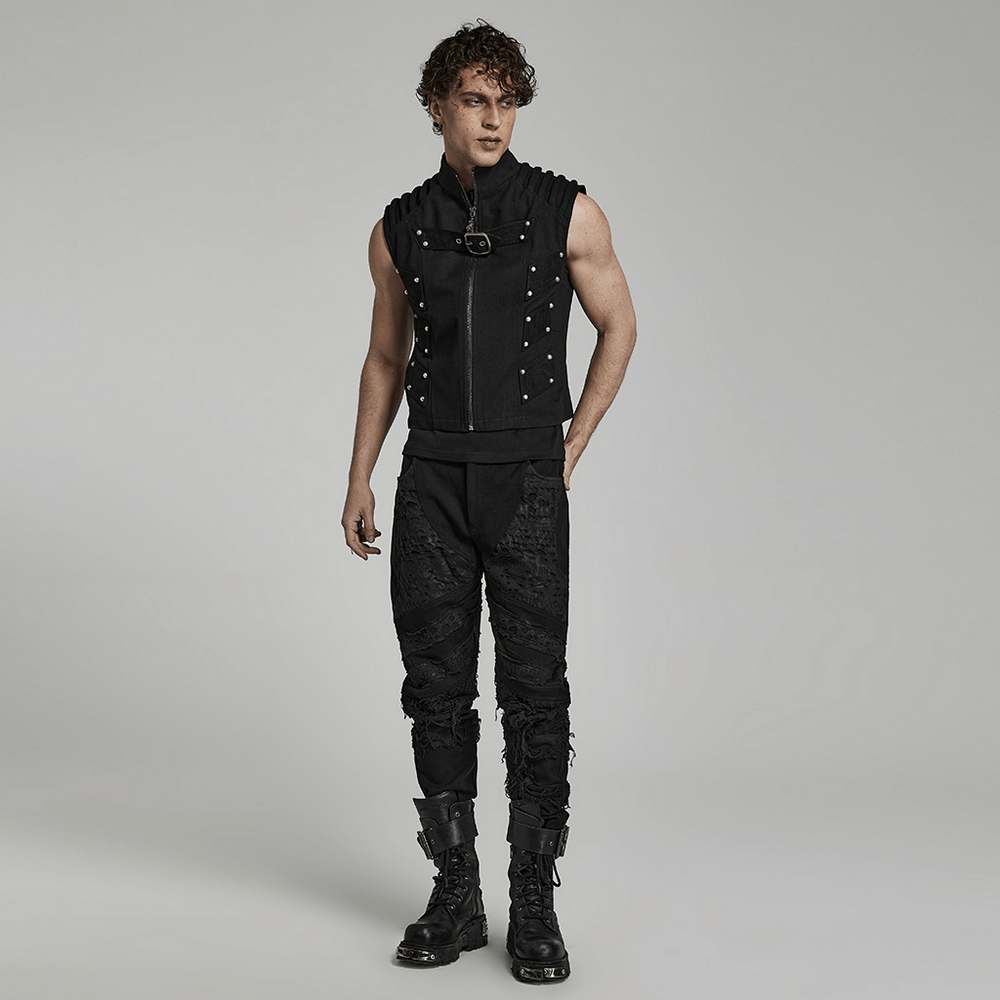 Edgy male model in a studded black punk vest and stylish pants, showcasing urban gothic street style.