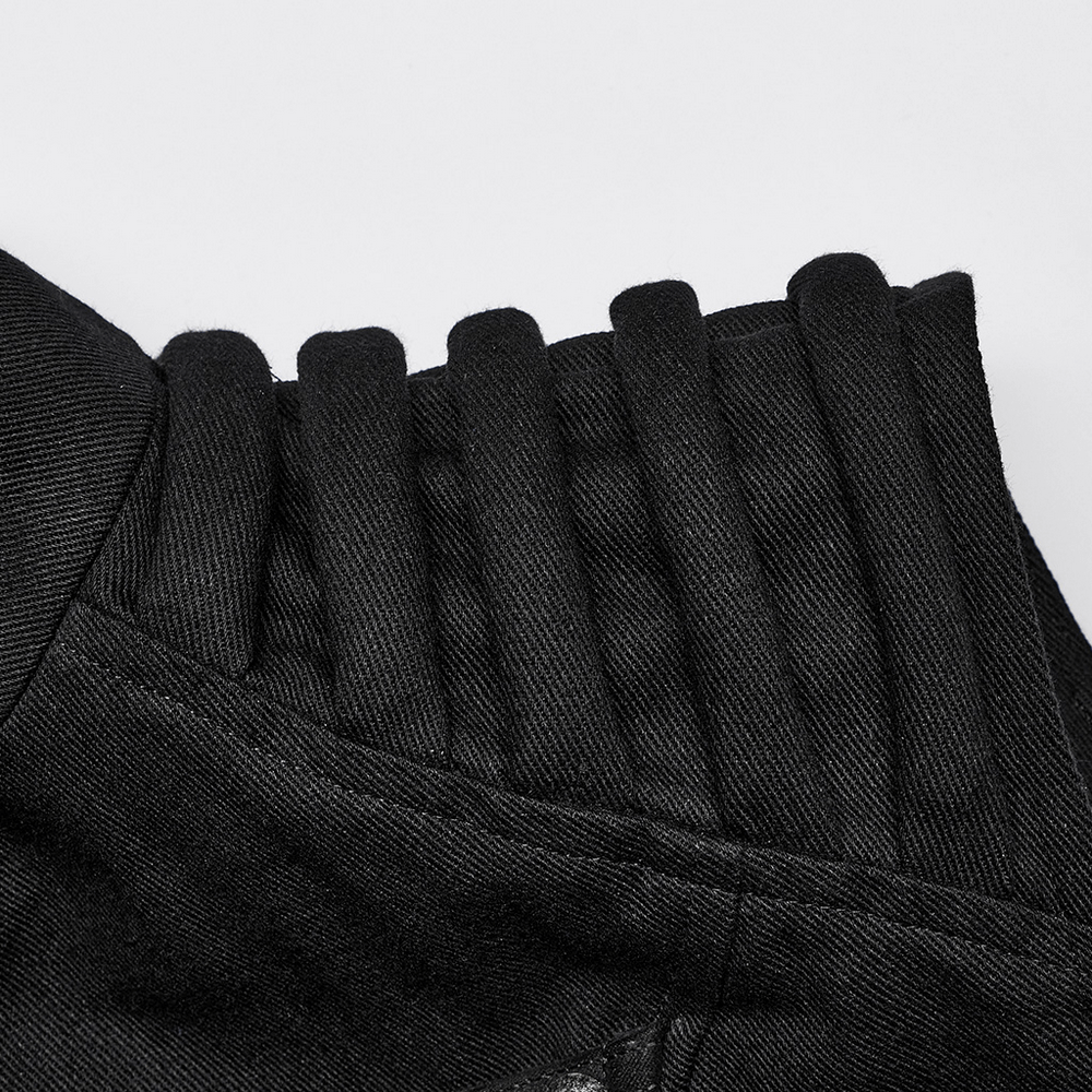 Close-up of the padded shoulder detailing on a studded black punk vest, showcasing its edgy texture and urban style.