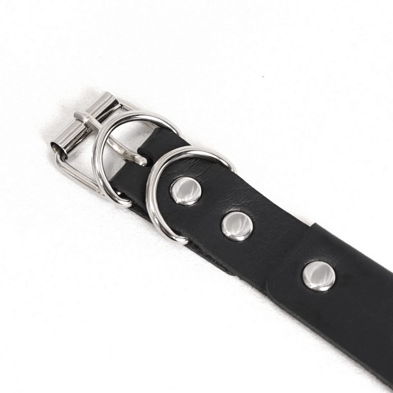 Close-up of a black leather belt with silver studs and a metal buckle, perfect for edgy fashion.