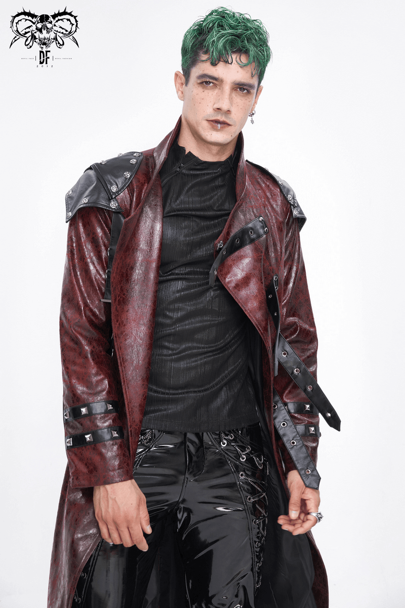 Model showcasing a bold red studded trench coat with green hair and edgy fashion style.