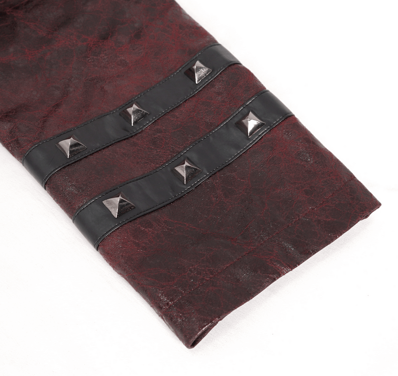 Close-up of a burgundy trench coat sleeve featuring studded black accents and stylish buckles.