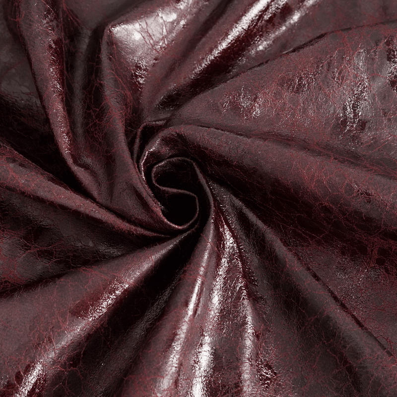 Close-up of luxurious dark burgundy faux leather fabric, showcasing a glossy and textured surface for stylish apparel.