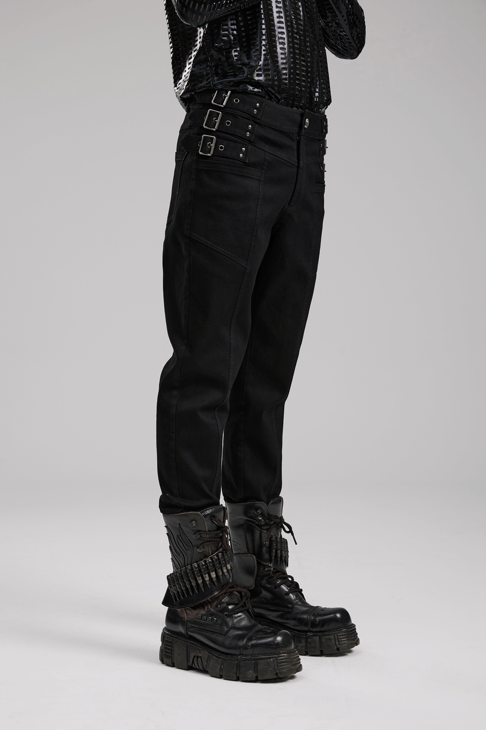 Black studded waist slim-fit gothic PUNK denim pants paired with chunky boots, showcasing edgy fashion details.