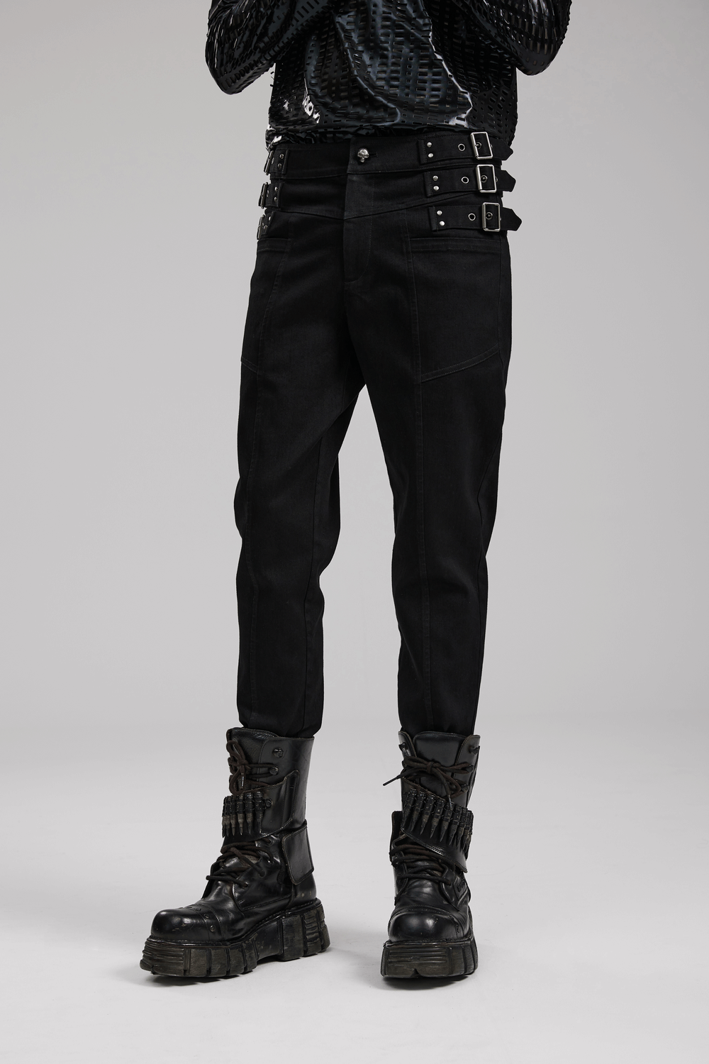 Men's slim-fit gothic PUNK denim pants with studded waist and edgy detailing, paired with chunky black combat boots.