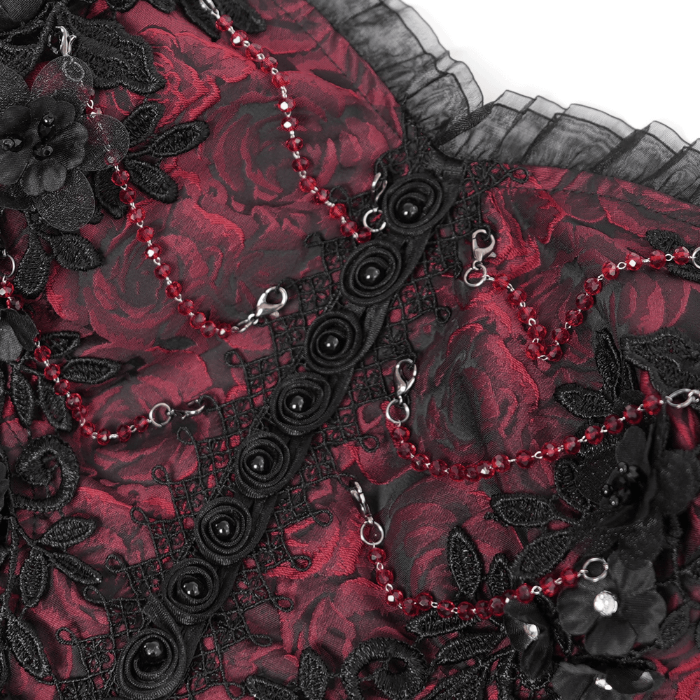 Close-up of stunning gothic floral corset dress in red and black with lace detailing and beaded embellishments.