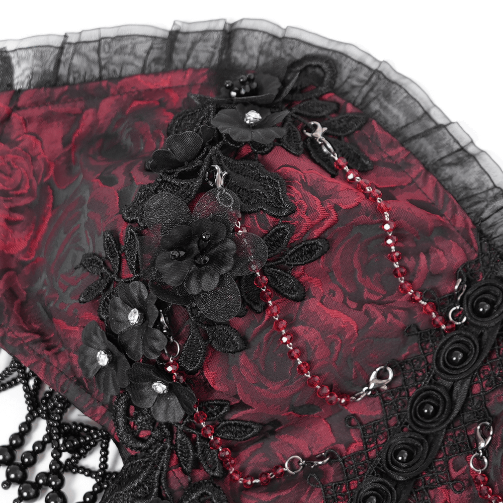 Close-up of gothic floral corset dress with dark red roses, lace, and bead detailing for a dramatic elegance.