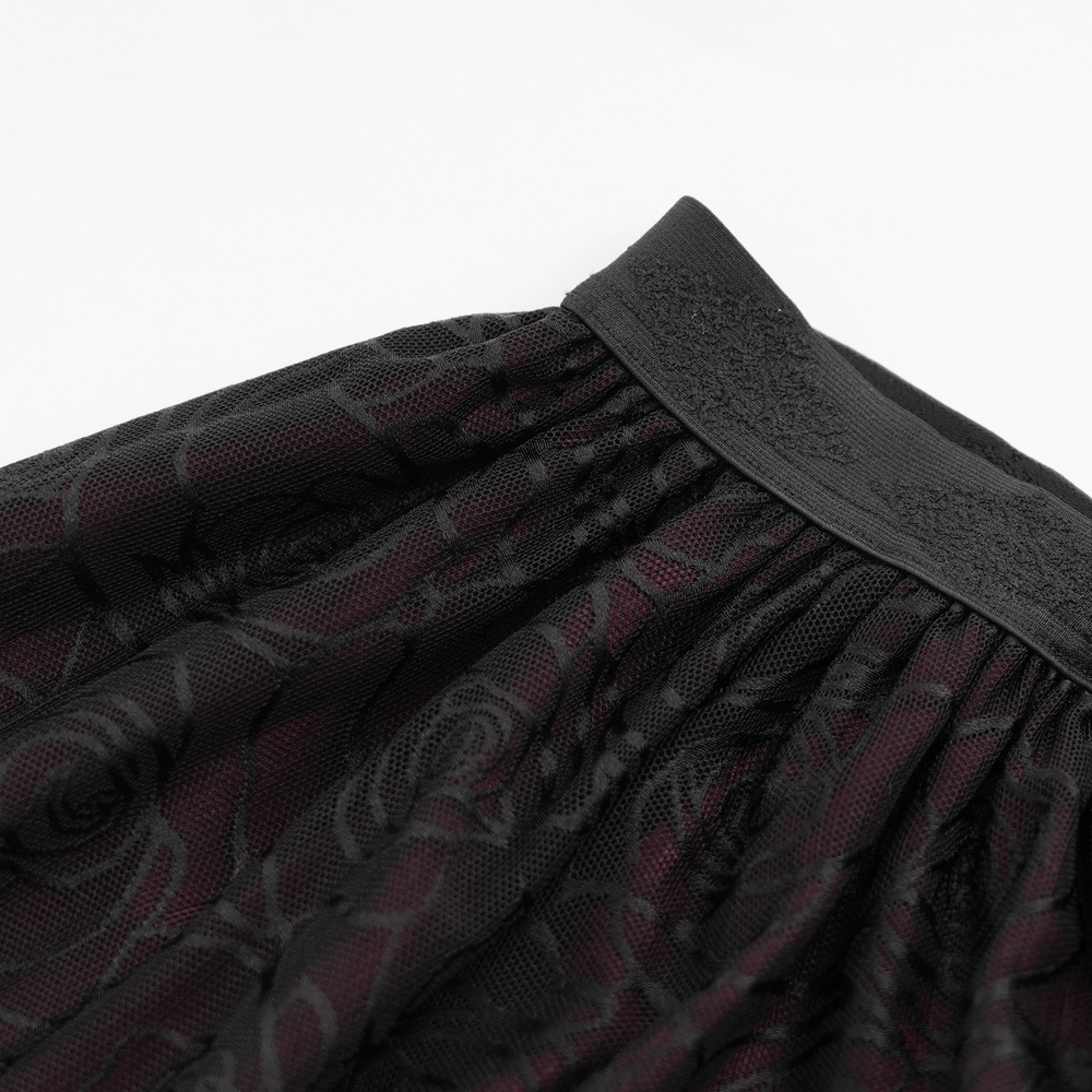 Close-up of the gothic floral lace detailing on a stunning corset dress skirt with intricate rose patterns.