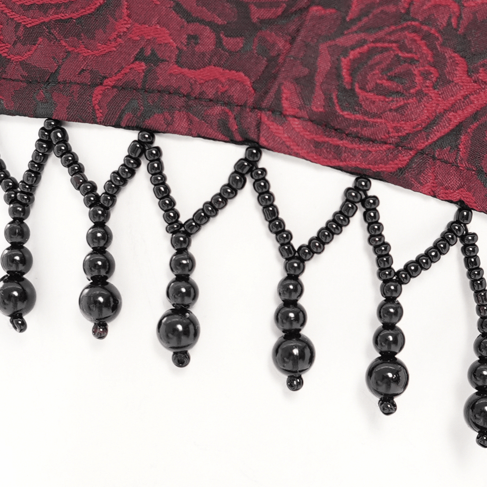 Close-up of intricate black beaded lace trim on a gothic floral corset dress with rose pattern.