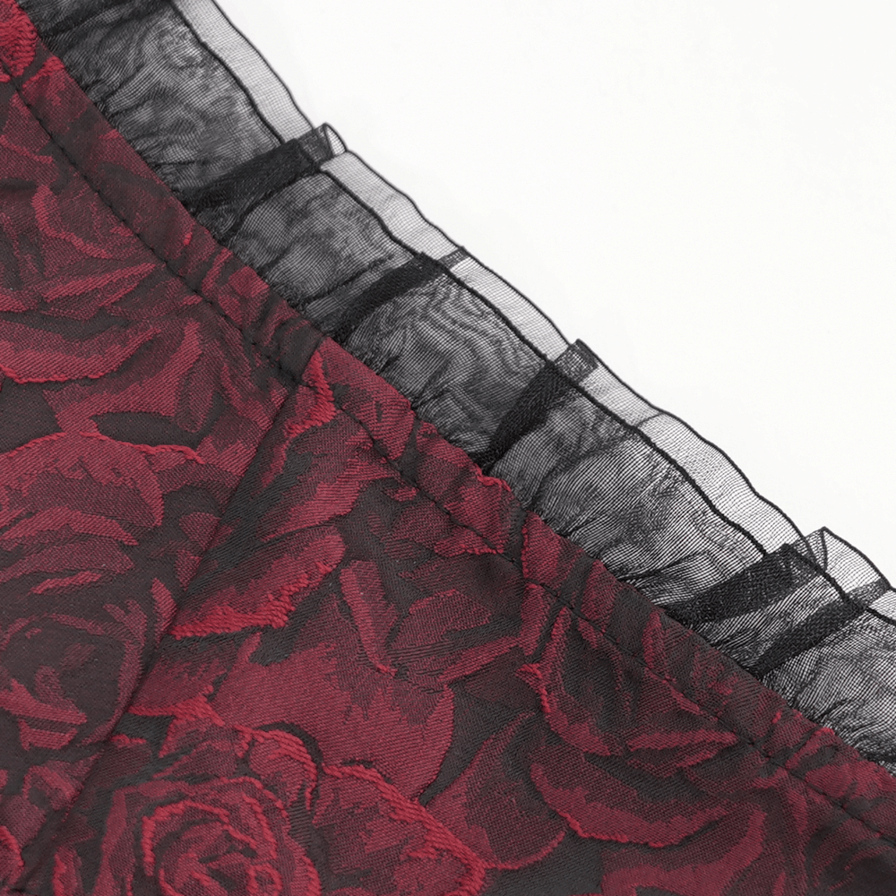 Close-up of lace detailing and red rose pattern on a gothic floral corset dress's skirt.