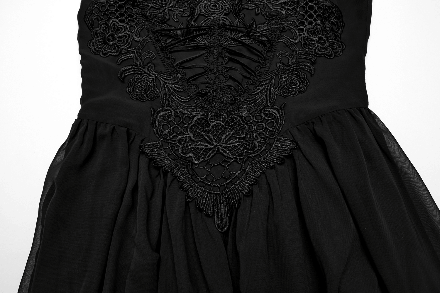 Close-up of a stunning gothic black chiffon dress with intricate floral embroidery and adjustable straps.
