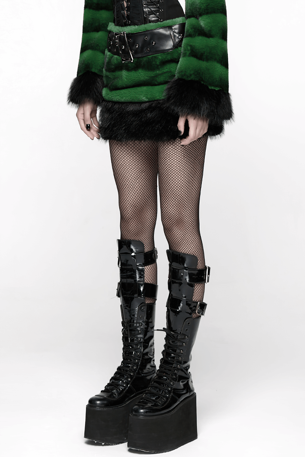 Stylish Black and Green Faux Fur Mini Skirt with Belt paired with fishnet tights and chunky black platform boots.