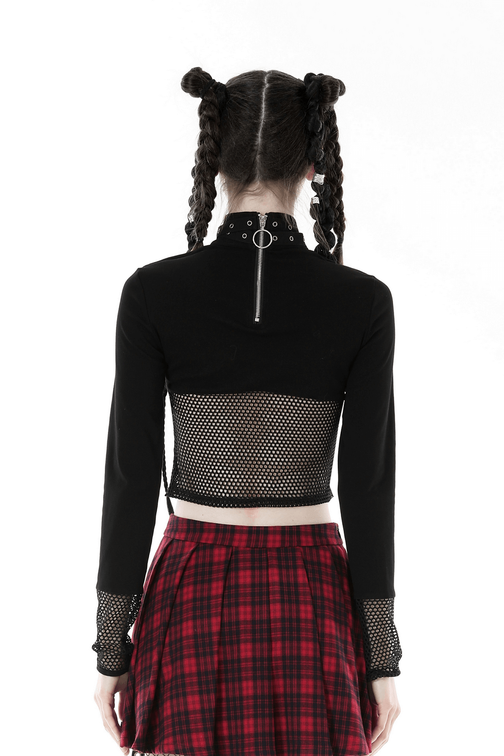 Back view of a stylish black crop top featuring mesh sleeves, cut-outs, and a plaid skirt, showcasing modern punk fashion.