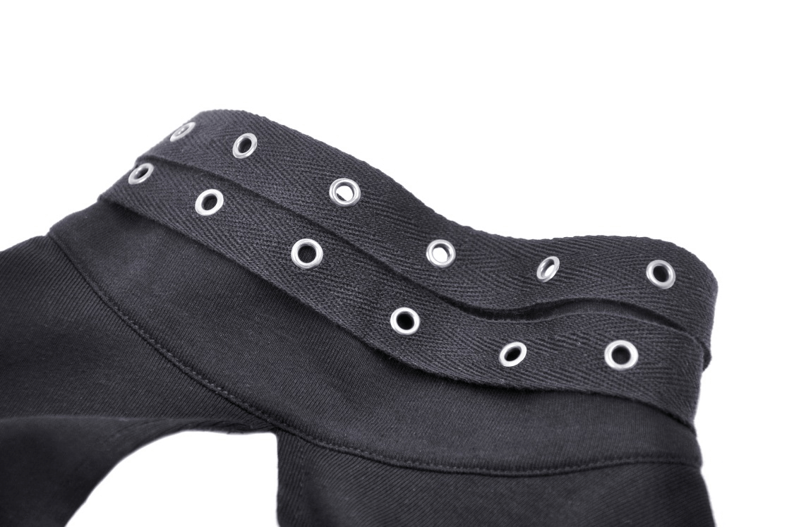 Close-up of a stylish black fabric detail featuring edgy grommets for a punk-inspired look.