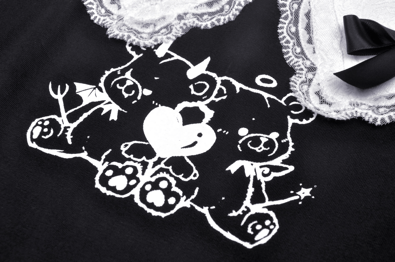 Playful graphic of black and white teddy bears with hearts on a stylish black crop top.