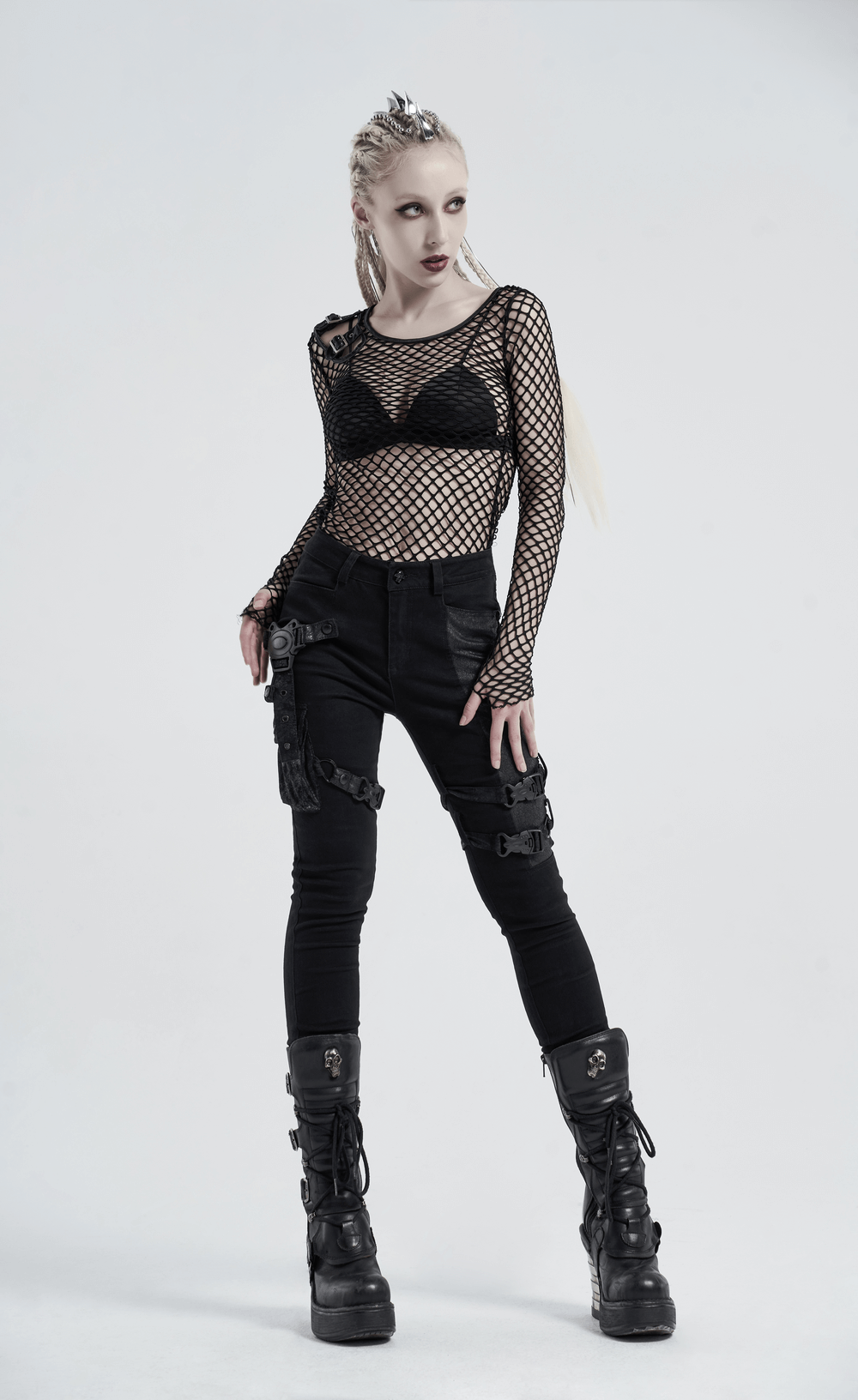 Edgy black fishnet mesh top with buckles, paired with stylish black cargo pants and chunky boots, perfect for a punk night out.
