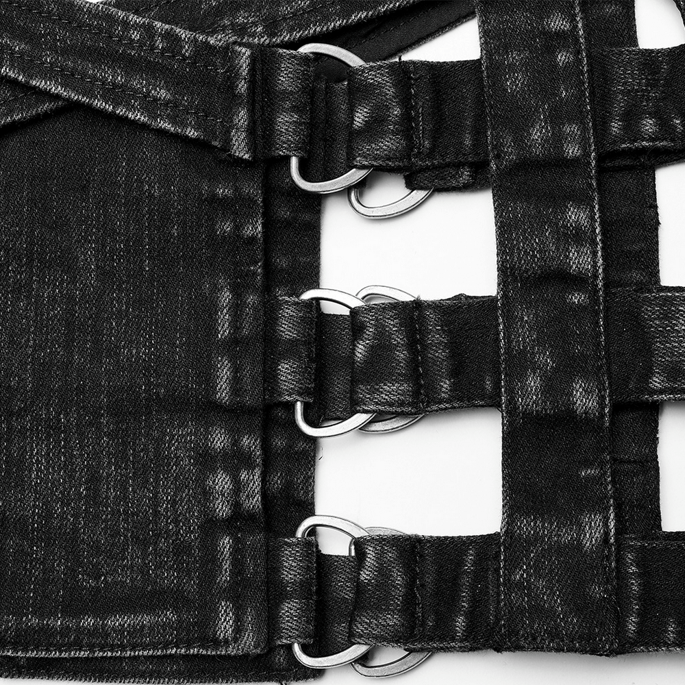Close-up of stylish black denim shorts featuring unique hollow-out design and detachable elements, perfect for punk style.