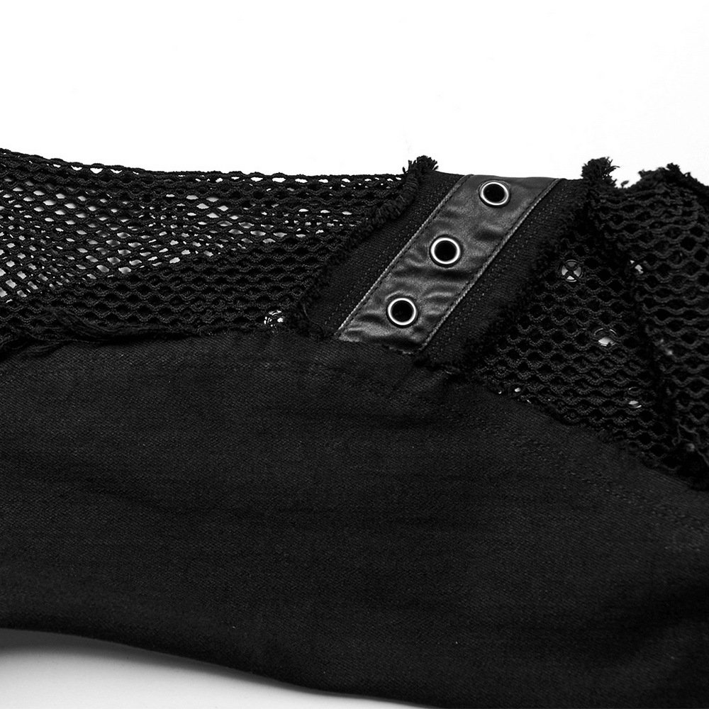 Close-up of black mesh with metal eyelet details on punk cross flare jeans, showcasing edgy style.