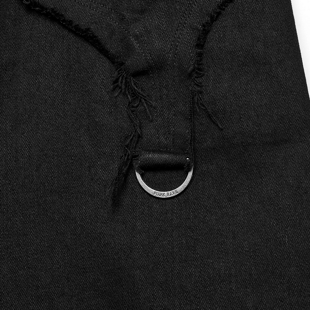 Close-up of black destroyed punk cross-flare jeans showcasing frayed detail and metal semicircle accents.