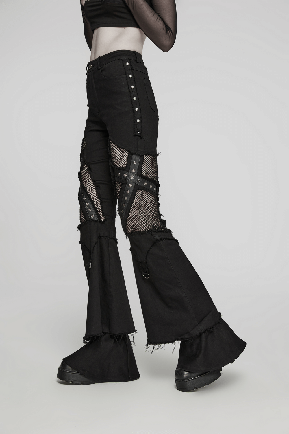 Edgy black destroyed punk cross flare jeans with mesh, eyelets, and flared hem for a rebellious look.