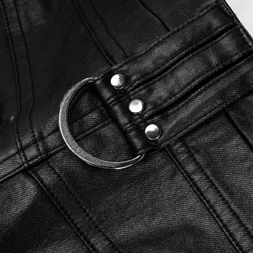 Close-up of a buckle detail on stylish black faux leather punk pants, showcasing edgy design elements.