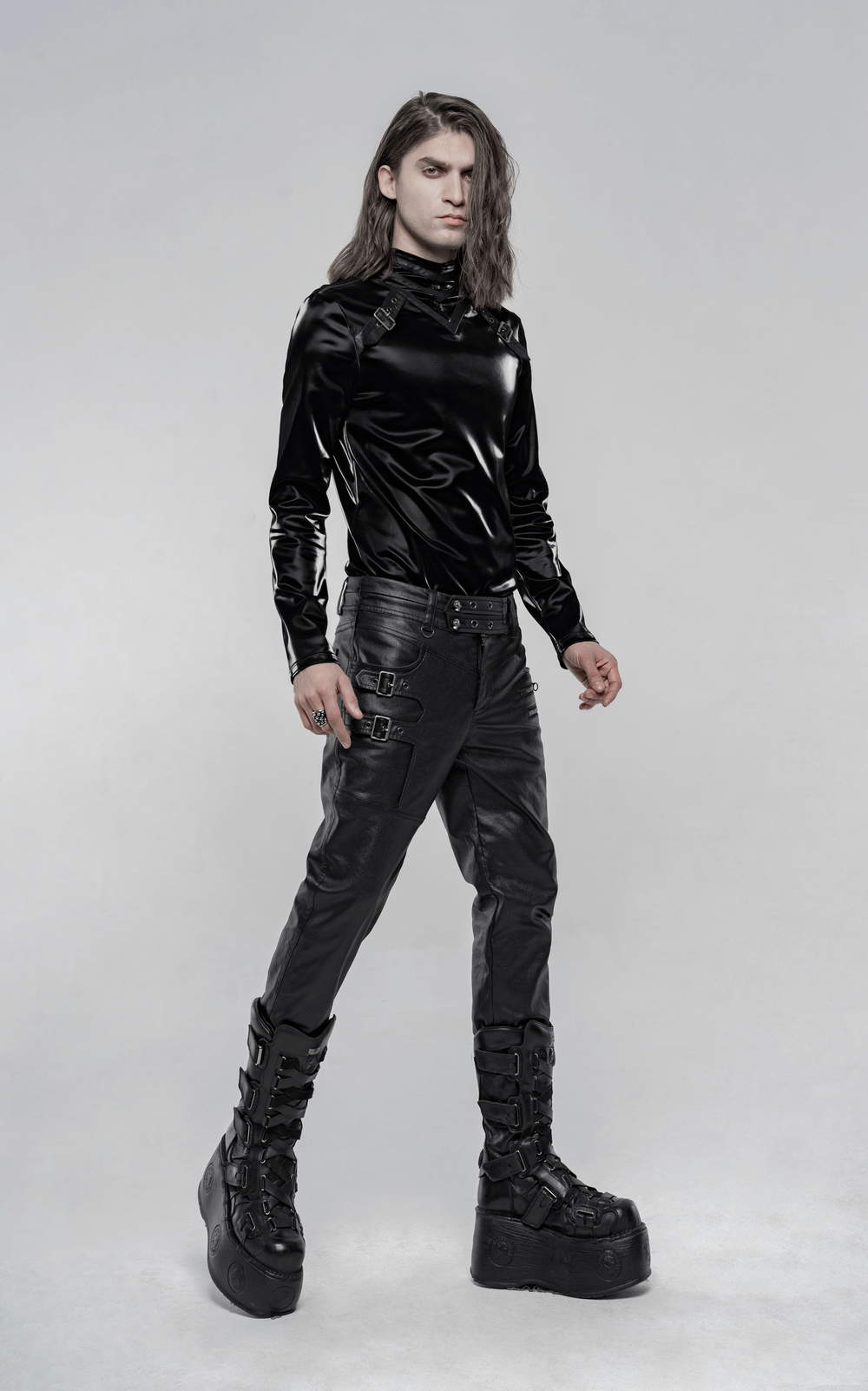Stylish black faux leather punk pants with buckles, paired with a sleek black top and platform boots.