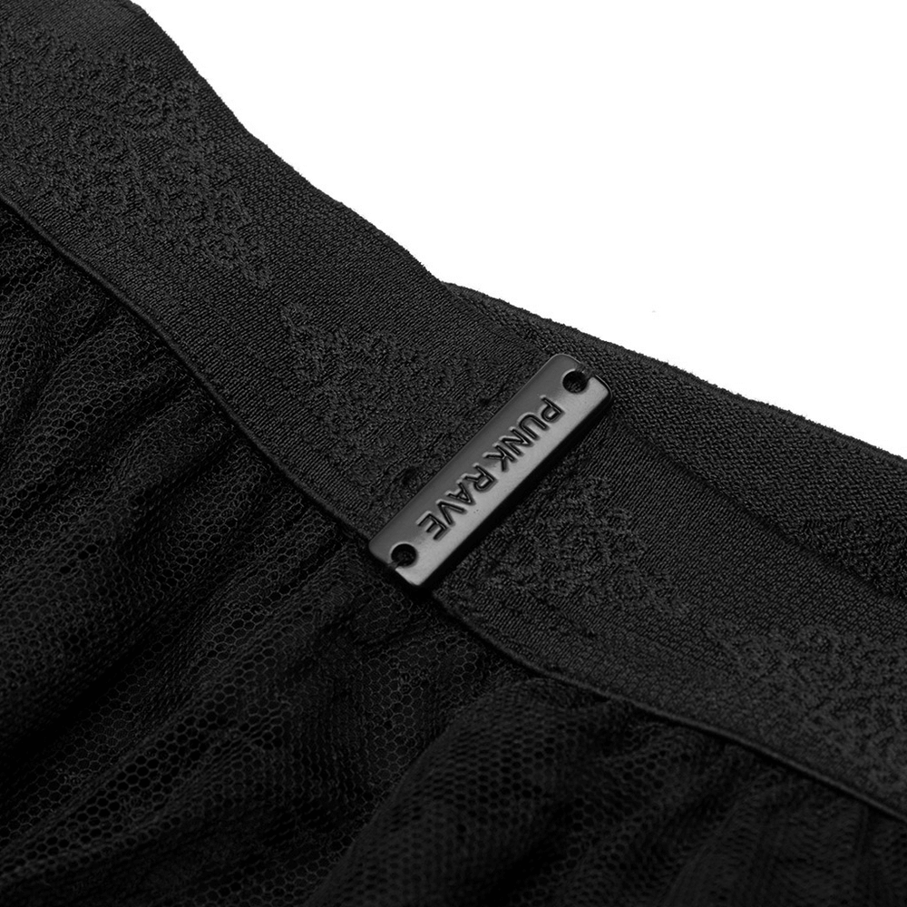 Close-up of the elastic waistband of a black gothic skirt featuring intricate lace and mesh texture.
