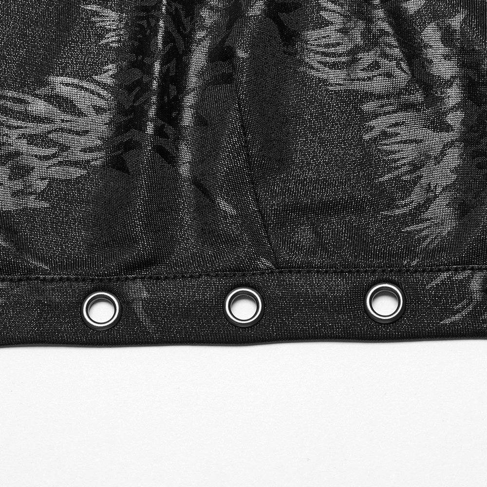 Close-up of stylish black halter crop top with large iron rings and unique textured fabric detail.
