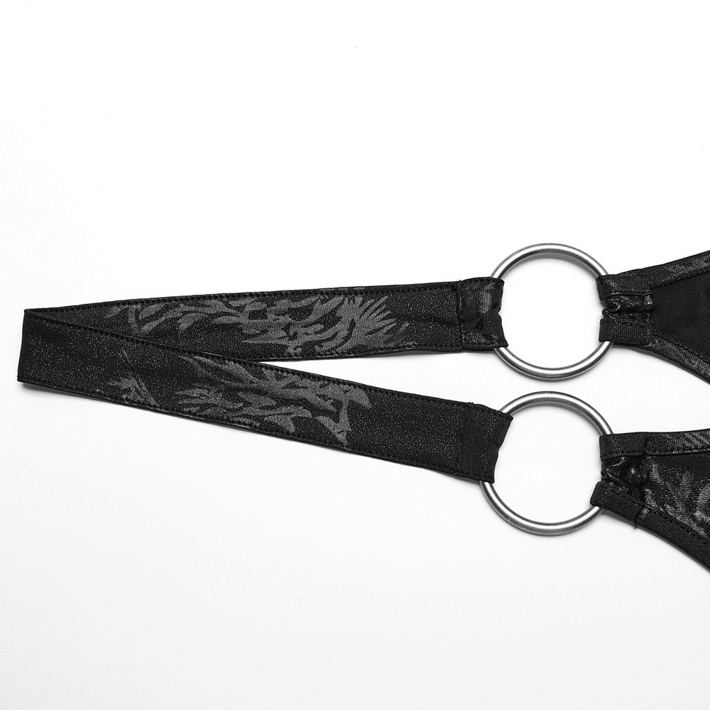 Close-up of black halter top straps with ring detailing, showcasing punk rock style and unique texture.