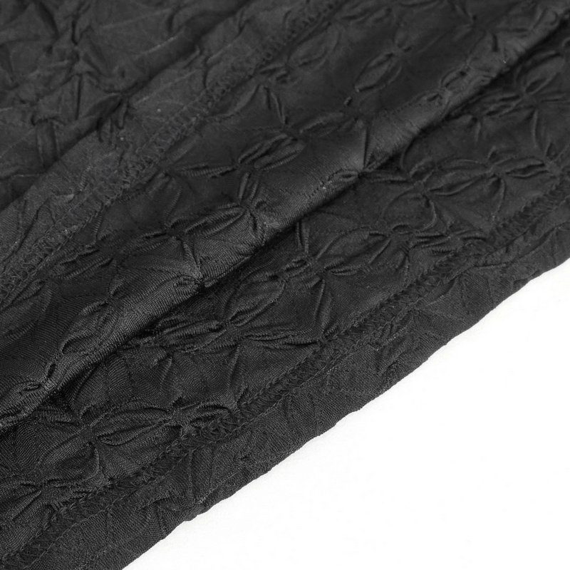 Close-up of textured black fabric with intricate patterns, showcasing stylish design for edgy fashion wear.
