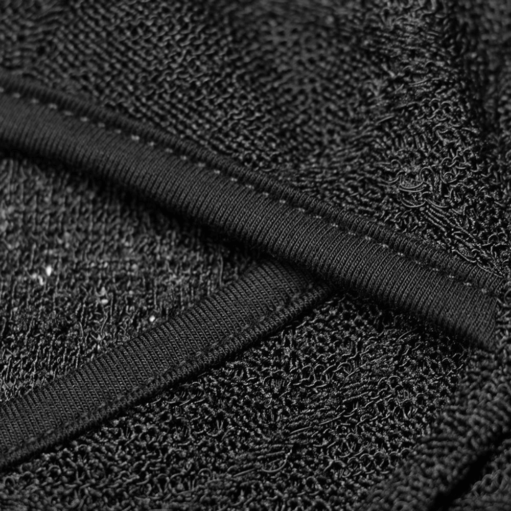 Close-up of black lace fabric with intricate texture and detailing for a stylish halter top.