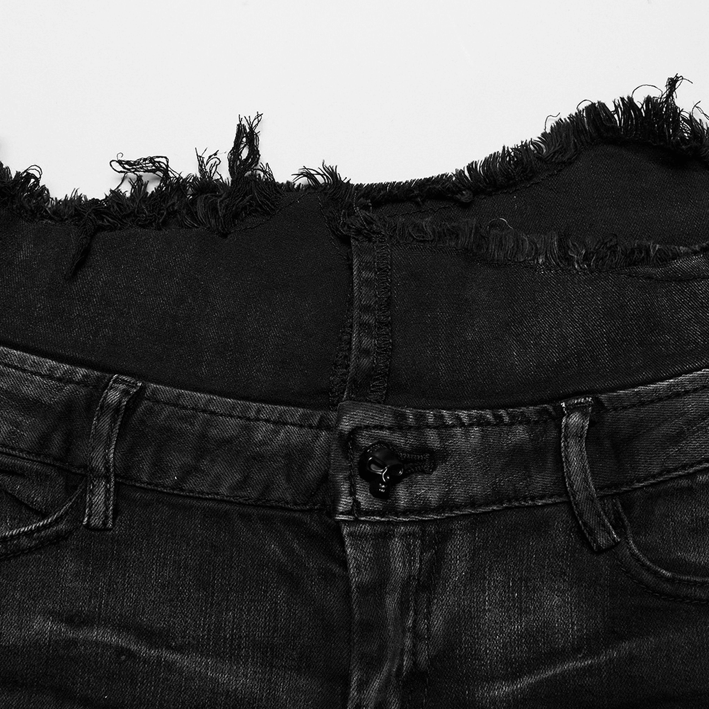 Close-up of the raw-edged waistline on stylish black lace-up denim hot pants with grunge detailing.