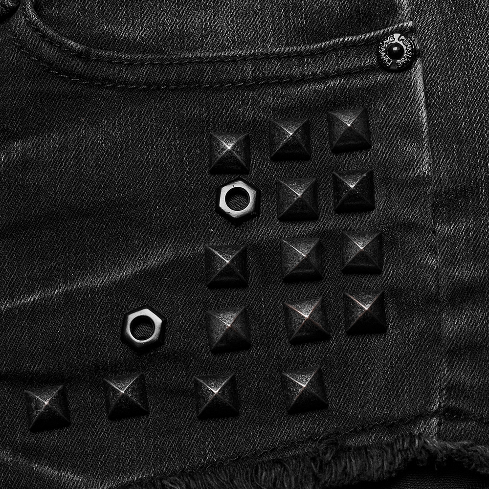 Close-up of edgy black denim featuring stylish square rivets and metal studs for a punk-inspired look.
