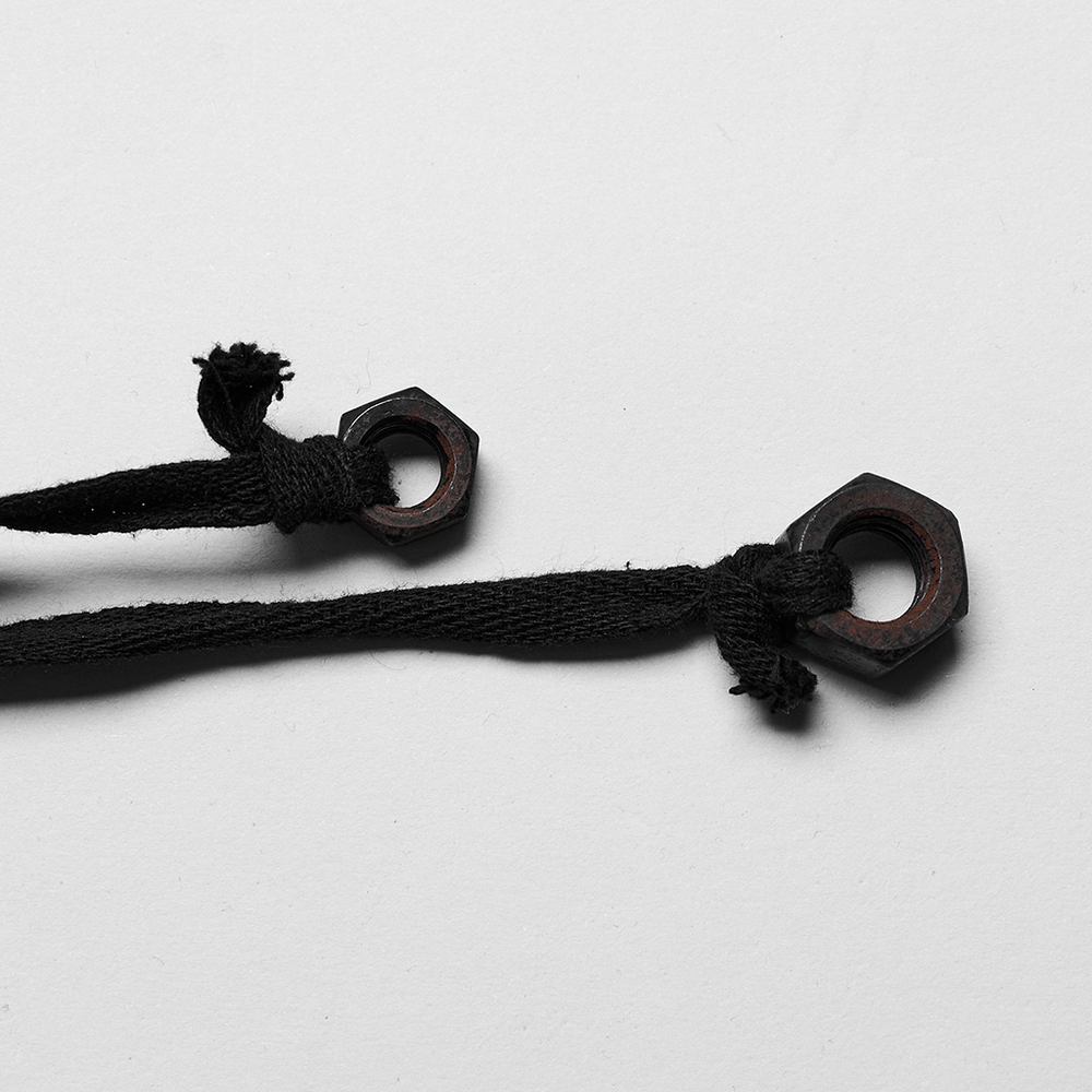 Close-up of black drawstrings with hexagonal metal ends, perfect for punk style fashion accents.