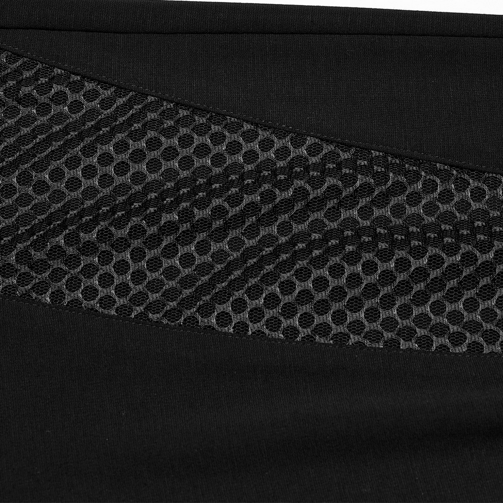 Close-up of stylish black leggings featuring honeycomb mesh side panels for a chic, punk minimalist look.