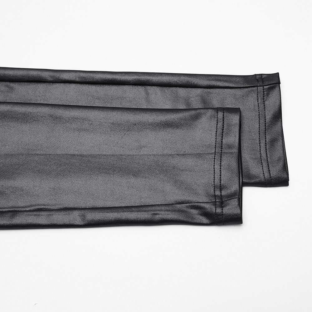 Stylish Black Leggings with Woven Cross and Buckle Detail close-up showcasing glossy texture and stitching details.