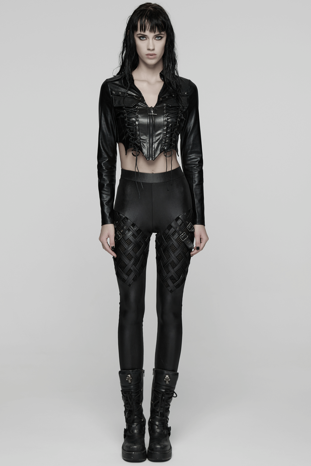 Stylish Black Leggings with Woven Cross and Buckle Detail worn by model in edgy black outfit.