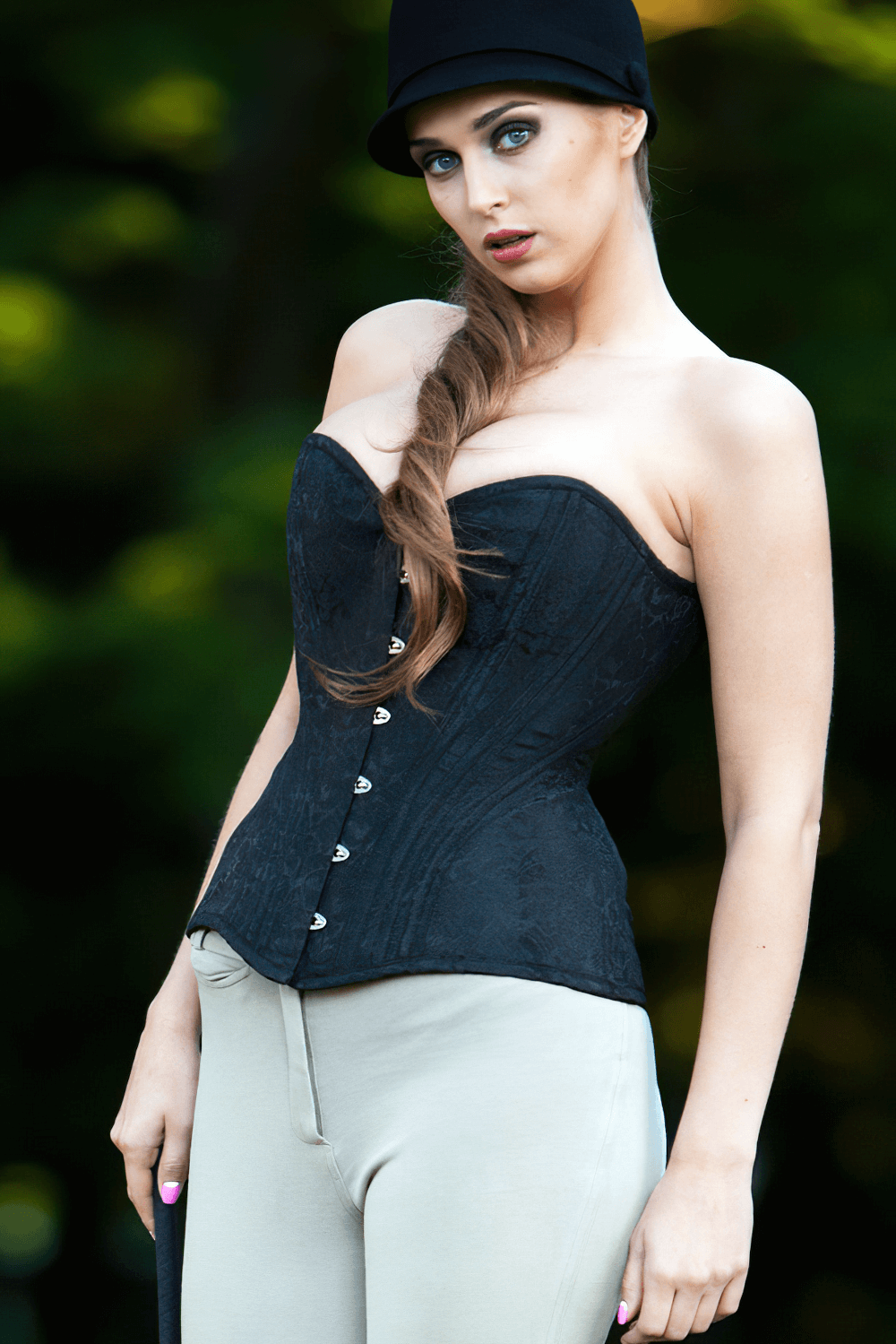 Gothic black overbust corset with steel boning, model wearing stylishly outdoors, perfect for waist training and layering.