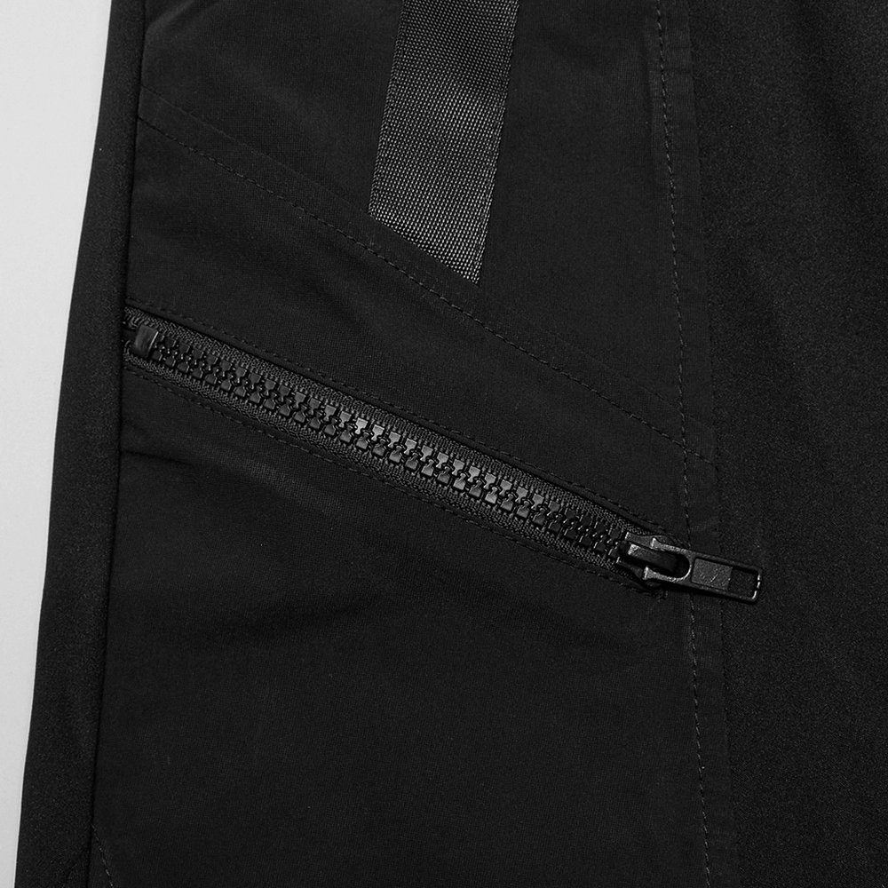 Close-up of stylish black techwear flared cargo pants showcasing a durable zippered pocket detail.