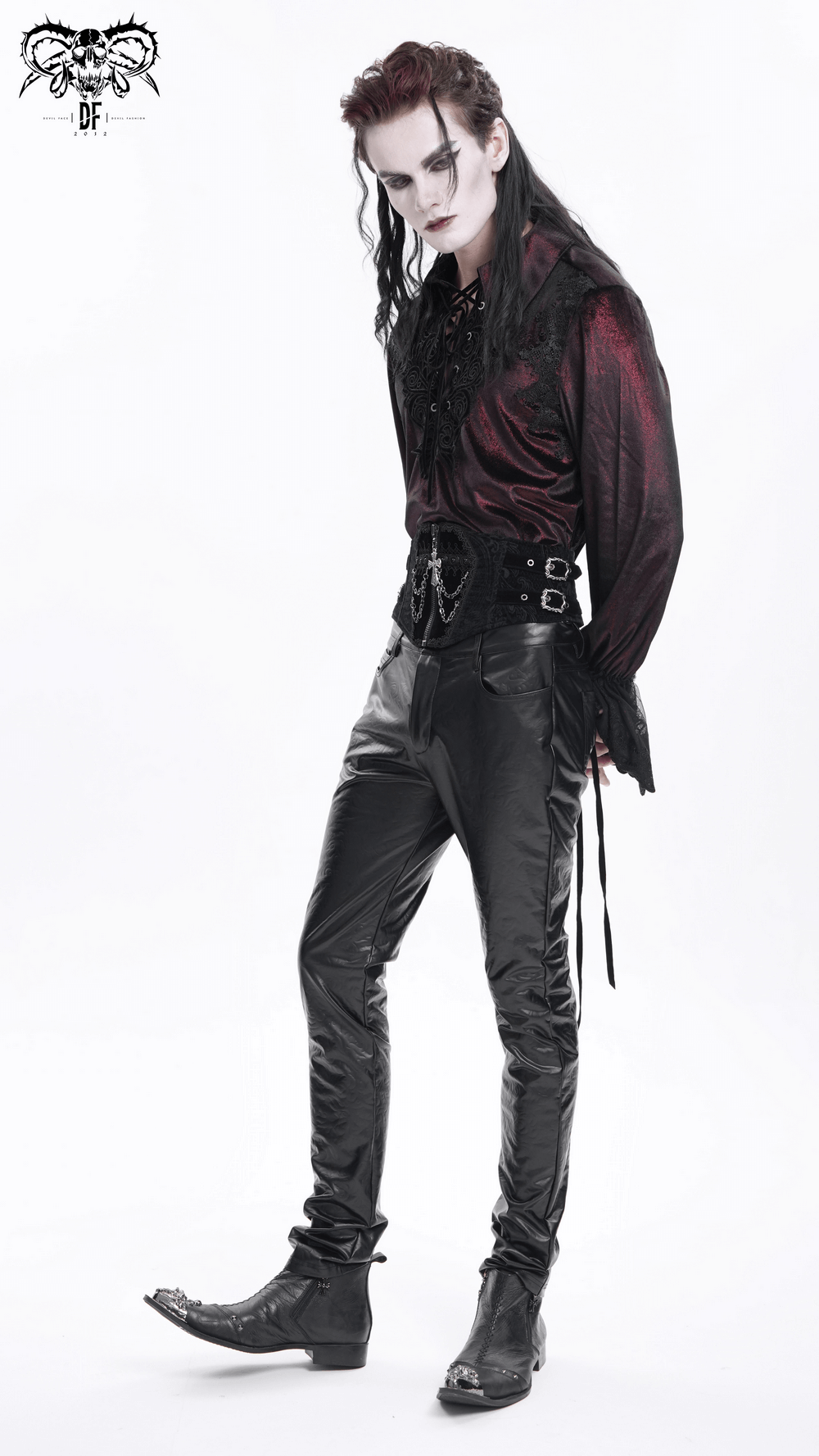 Stylish male model in black leather trousers and a gothic red shirt, showcasing a sleek rock-inspired look.