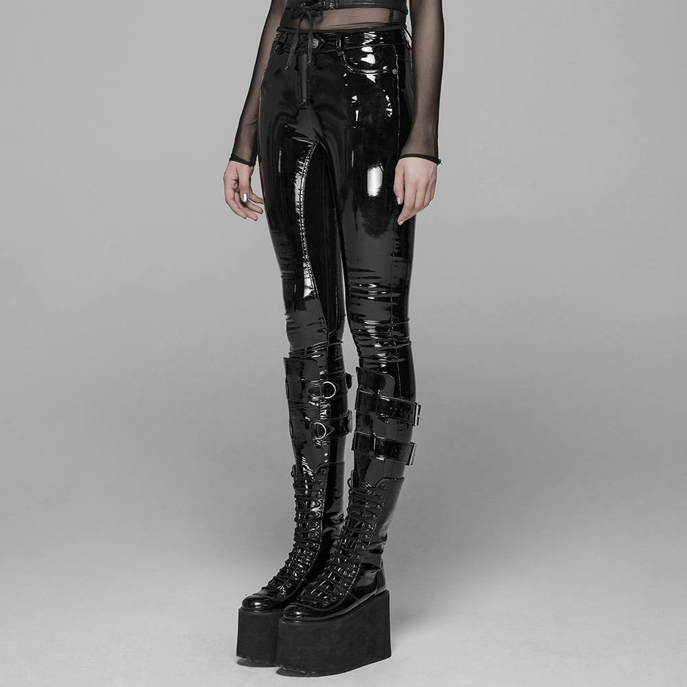 Chic high-waisted black shiny vinyl leggings with zip closure, paired with edgy platform boots.