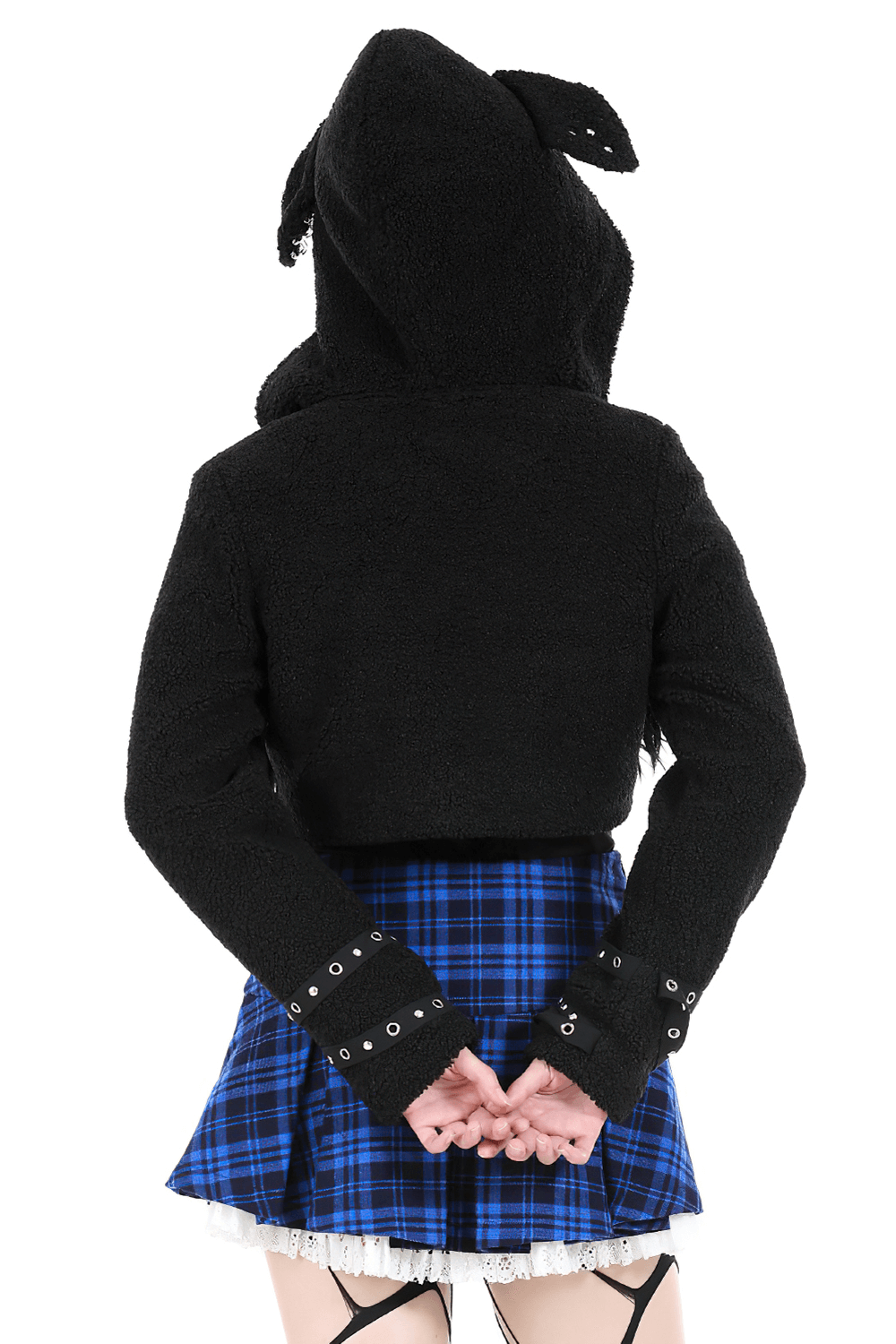 Back view of stylish black cropped hoodie with dog ears and spikes, paired with a plaid skirt, showcasing a bold fashion statement.