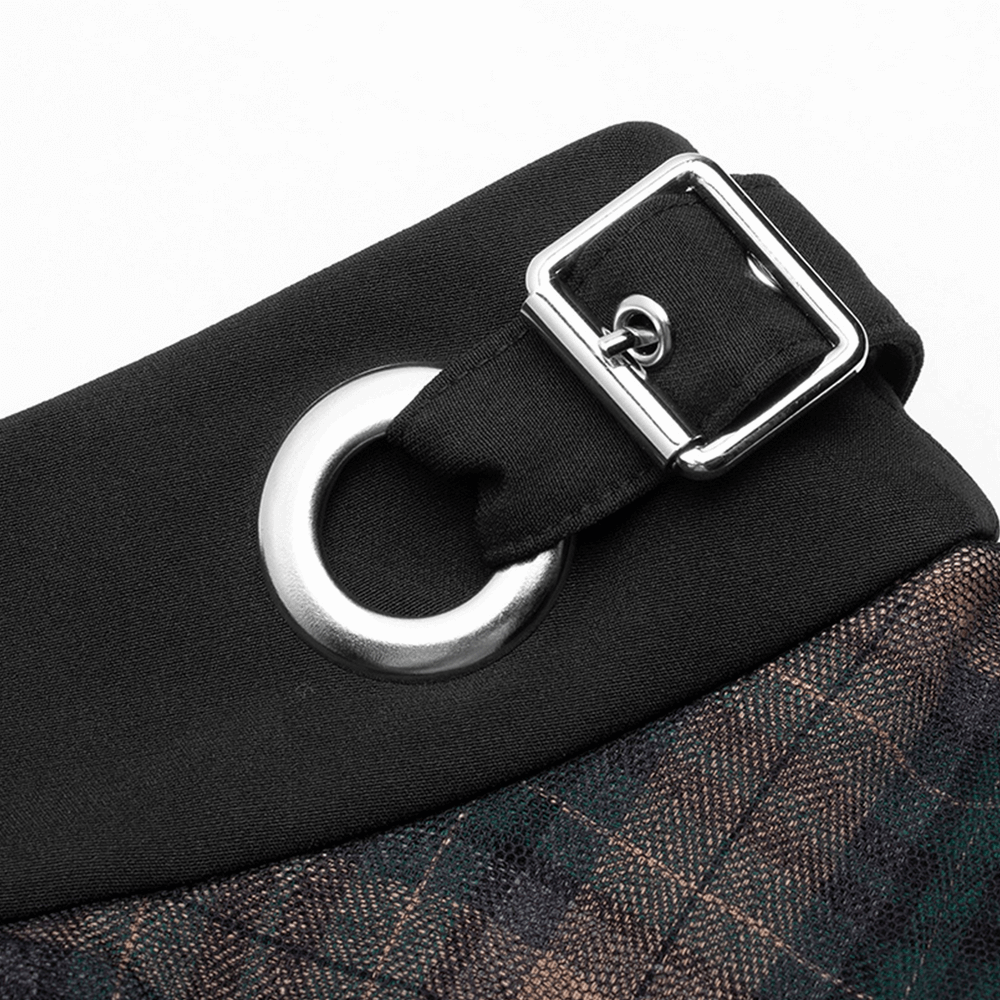 Close-up of the stylish buckle detail on the waistband of a dark punk plaid mesh skirt.