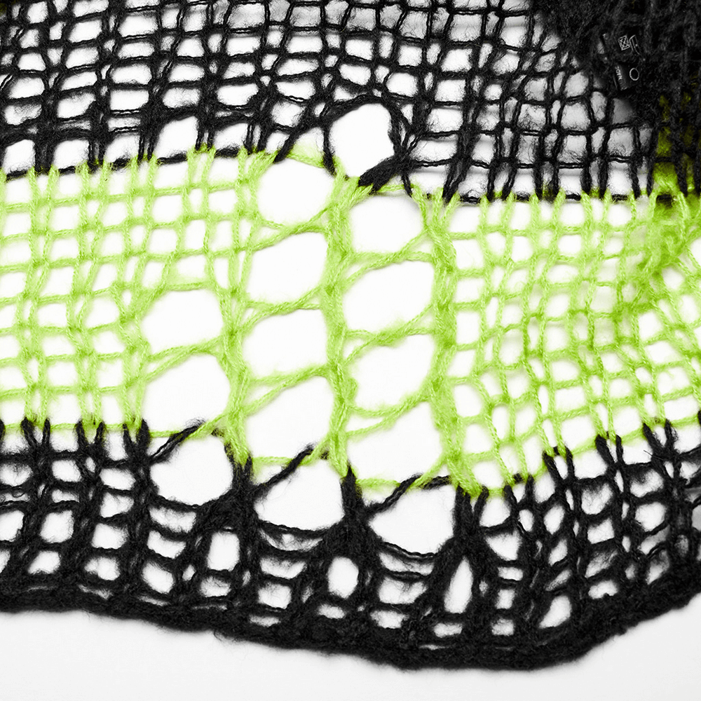 Close-up of a stylish black and neon green mohair knit pattern showcasing edgy, distressed design details.