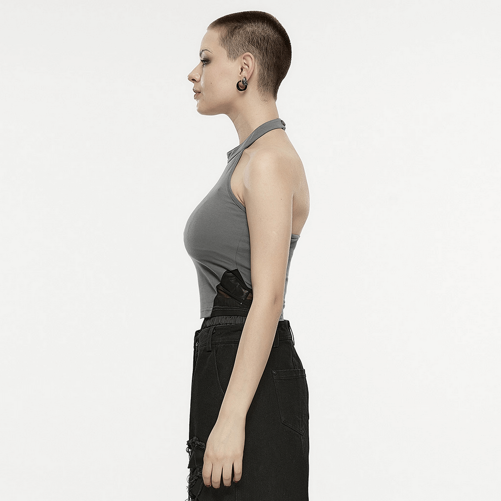 Side view of a stylish woman wearing a halter neck top with a unique design, showcasing modern fashion flair.