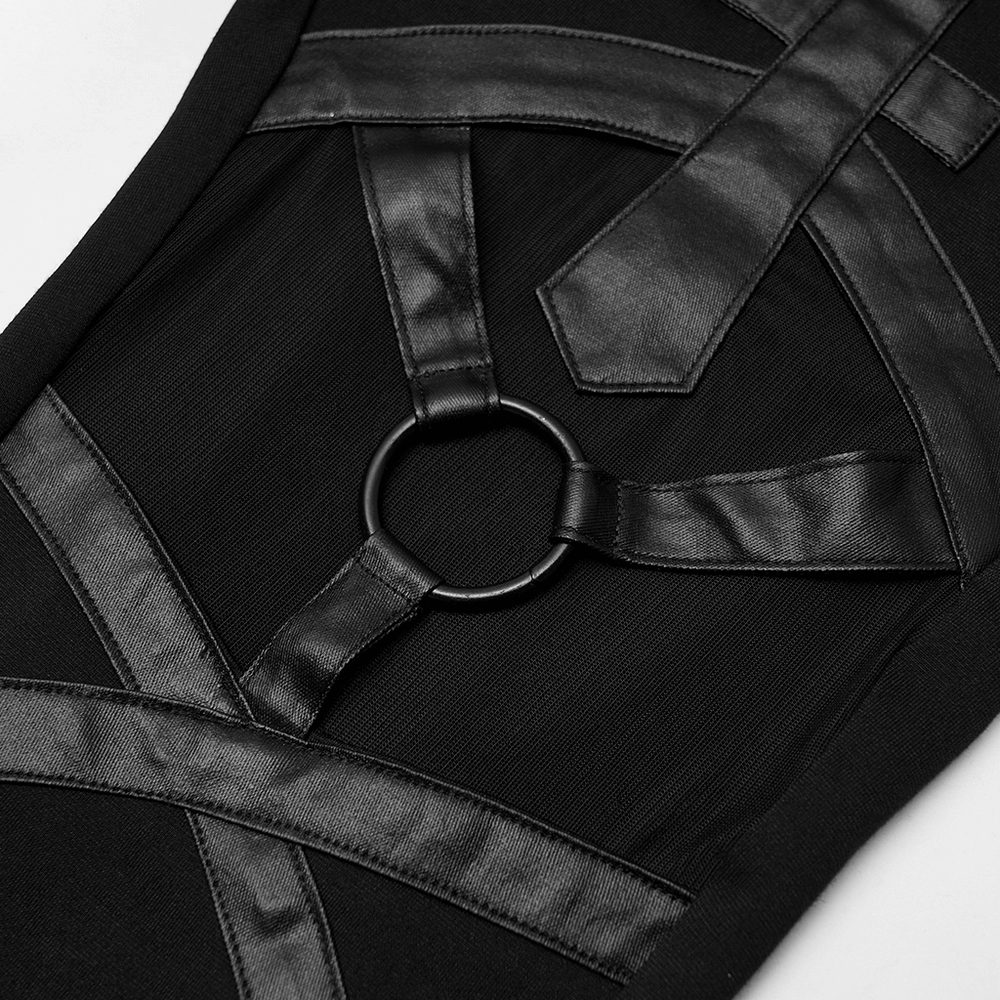 Close-up of black mesh-paneled leggings with iron ring and leather-like straps, showcasing gothic-inspired fashion.
