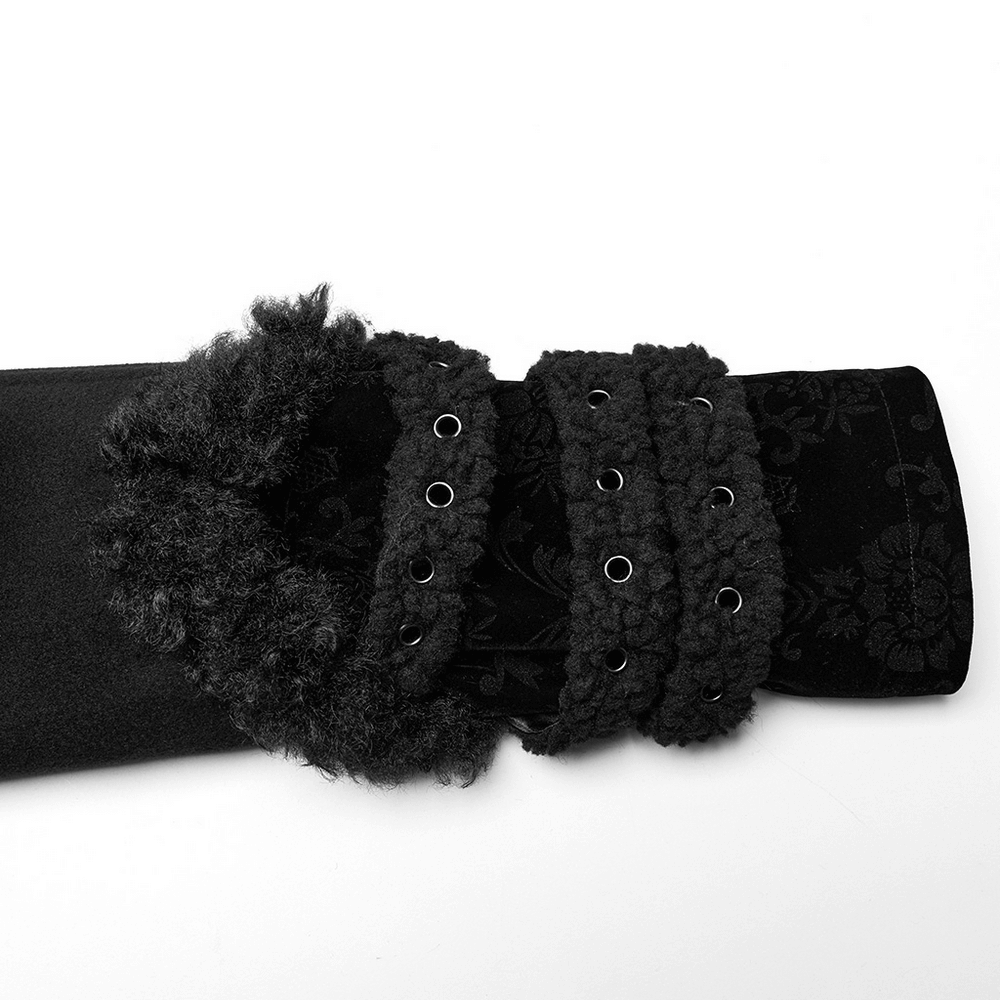 Close-up of the plush-striped sleeve of a stylish gothic coat featuring jacquard trim and decorative buckle accents.