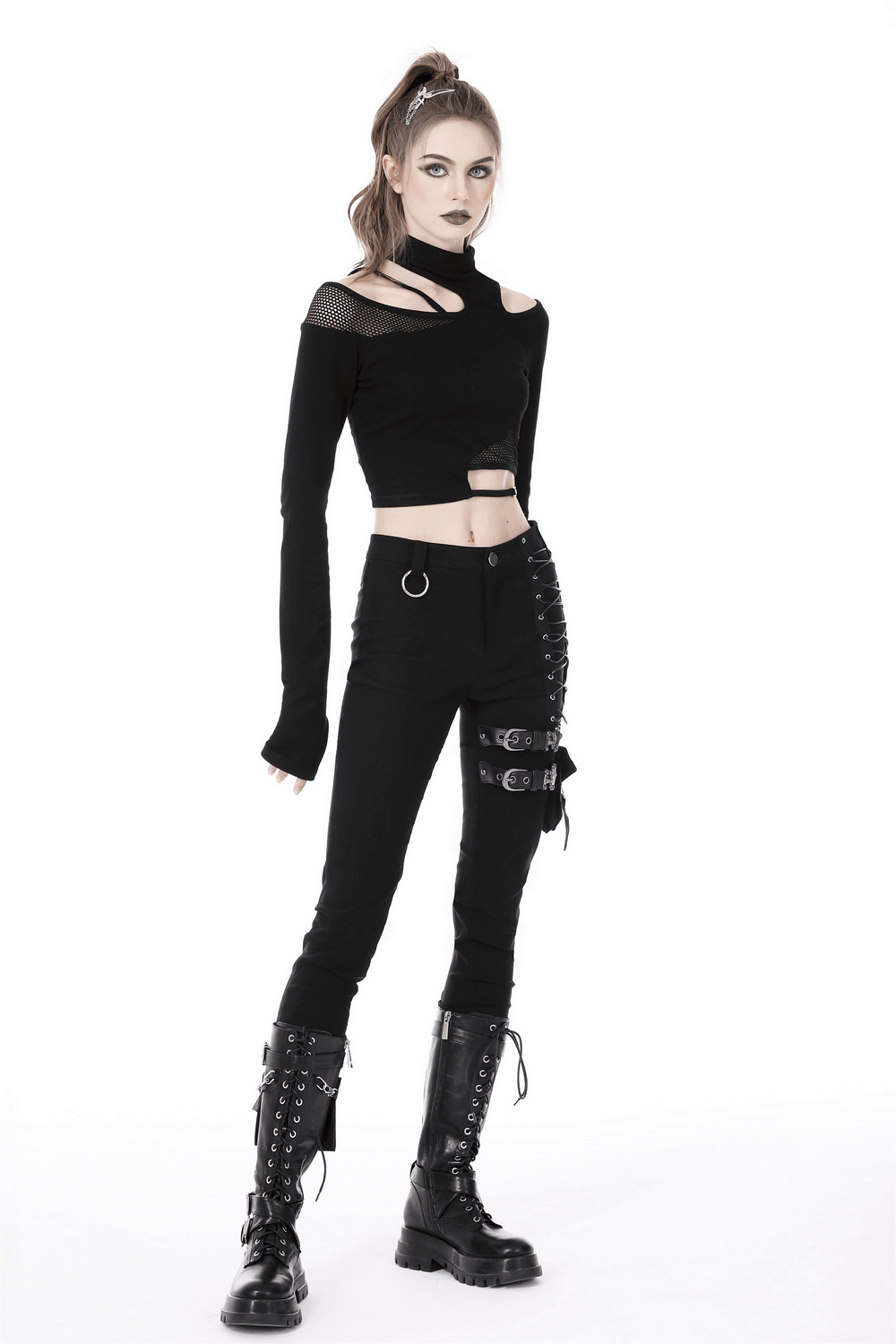 Gothic female model in an asymmetrical off-the-shoulder top and dark punk pants, exuding edgy style.